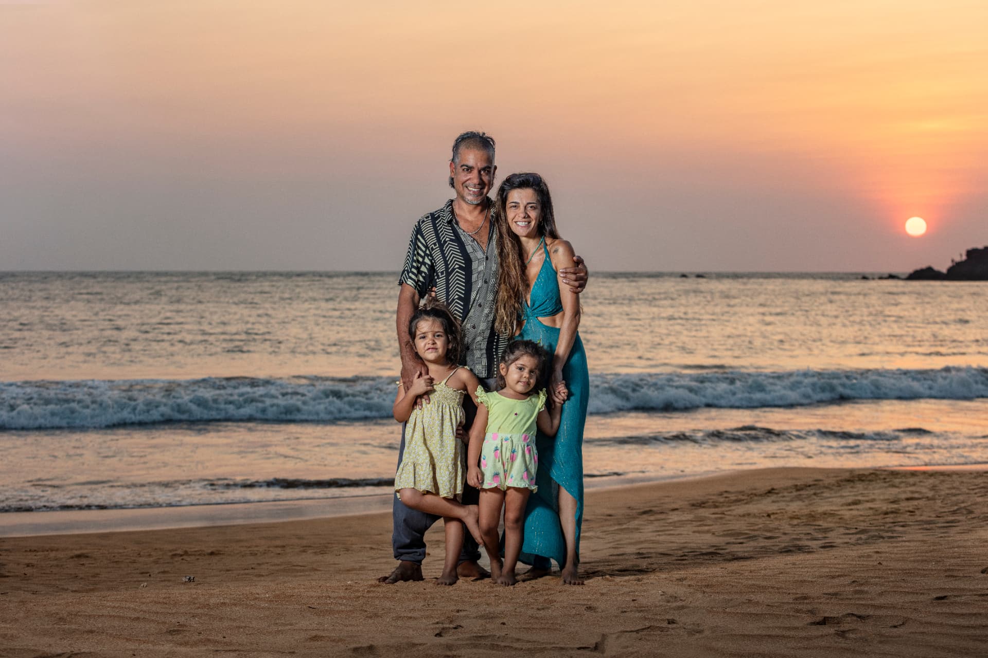 Roy and Yeliz Smila with their family at the beach at sunset